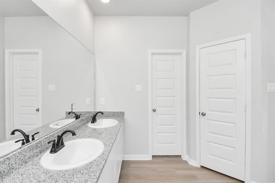 Alongside a spacious walk-in closet with shelving, high ceilings, custom paint, andsleek, dark modern finishes. An ideal retreat for unwinding after a long day.