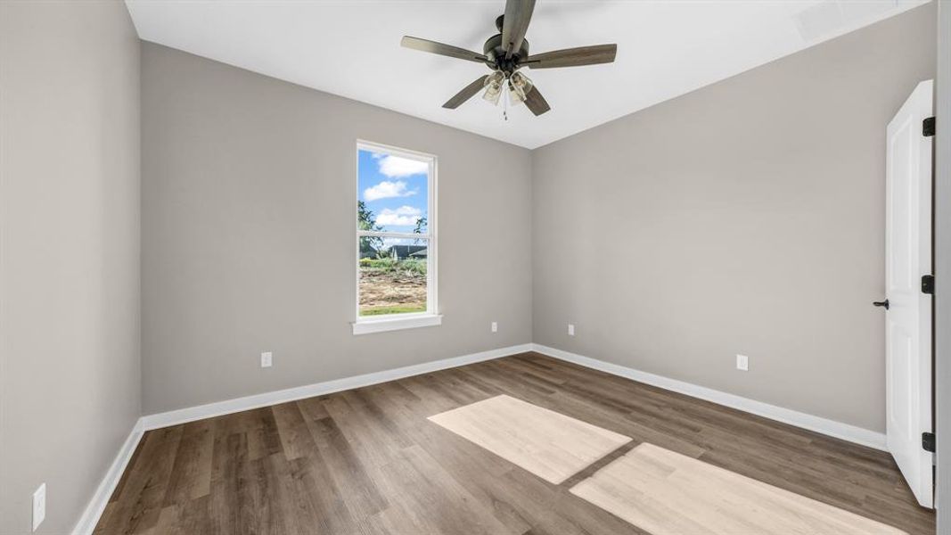 Bedroom with wood-type flooring and ceiling fan