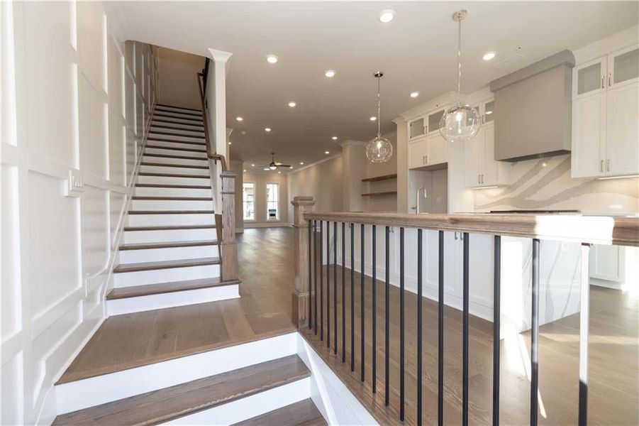 Entering from your front door......Sunkissed Hardwood Flooring on main level includes Stairs with wood finished floors, tonos of natural light and beautiful finishes.  Image is off a previously built Chamberlain plan