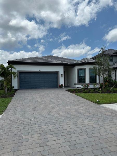 Front exterior of a new home in Lakespur Wellen Park, Venice, FL, highlighting curb appeal (Image 2).