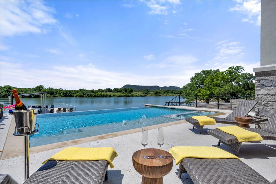 Resort-style infinity-edge pool with integrated spa and mountain views.