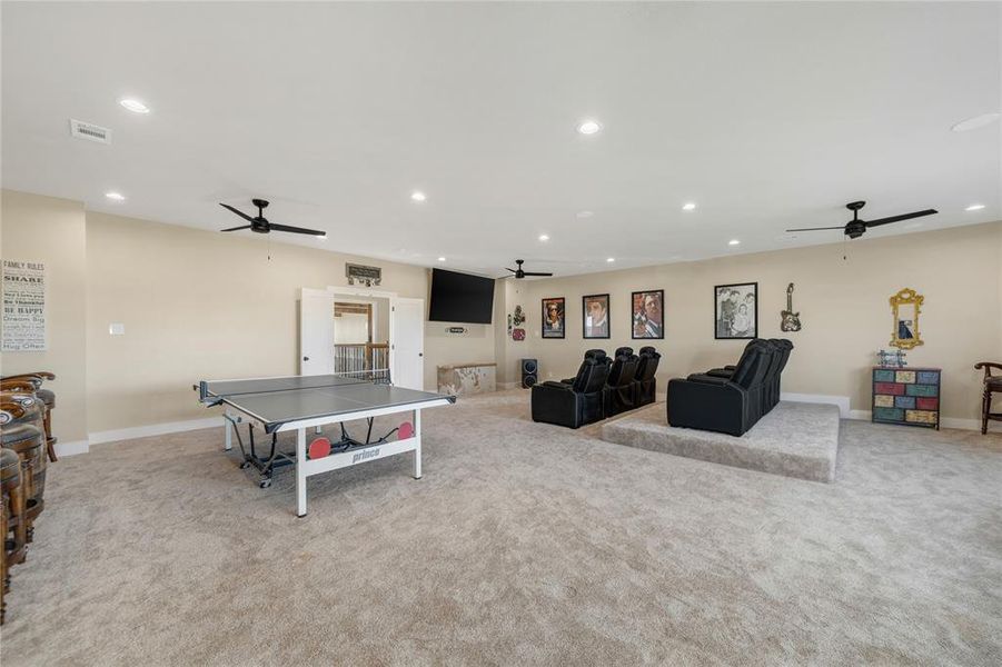 Rec room with a ceiling fan, recessed lighting, and light carpet
