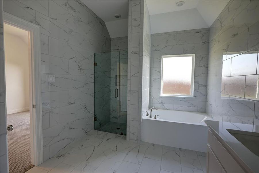 Bathroom with a garden tub, a marble finish shower, vanity, and marble finish flooring Bathroom with a garden tub, a marble finish shower, vanity, and marble finish flooring