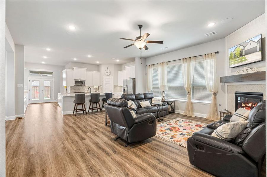 Open-concept living space featuring wood-finish flooring, recessed lighting, and a ceiling fan Open-concept living space featuring wood-finish flooring, recessed lighting, and a ceiling fan