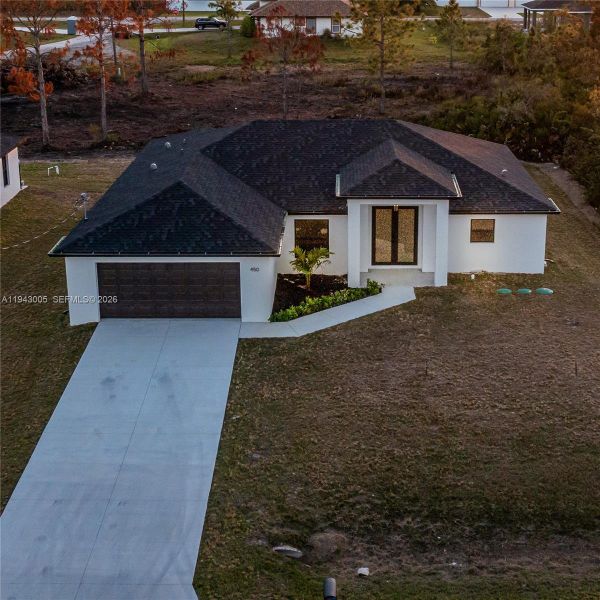 Front exterior of a new home in , Lehigh Acres, FL, highlighting curb appeal (Image 20). Front exterior of a new home in , Lehigh Acres, FL, highlighting curb appeal (Image 20).