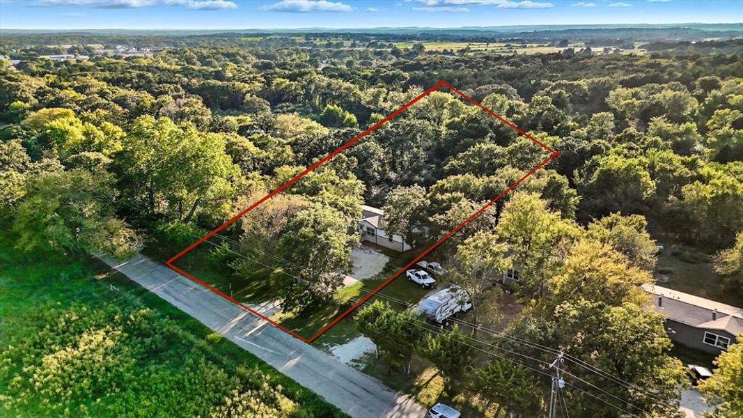 Aerial overview of property's location featuring property parcel outlined and a forest Aerial overview of property's location featuring property parcel outlined and a forest