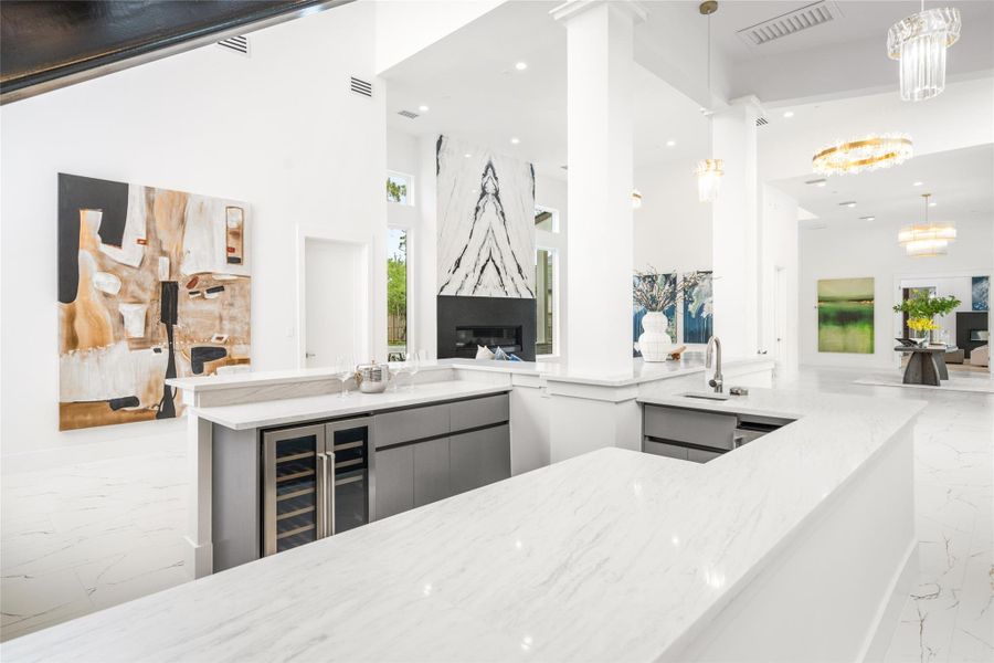 Imagine the lively conversations and laughter shared around the expansive wet bar—complete with an ice maker, sink, and dual-zone wine fridge. Imagine the lively conversations and laughter shared around the expansive wet bar—complete with an ice maker, sink, and dual-zone wine fridge.