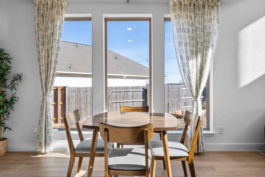 Dining space with wood finished floors and baseboards