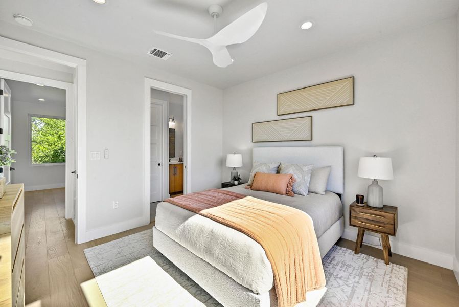 3rd Floor Primary Bedroom with a generous amount of space. (This is Unit #2 - each Unit has the same layout, however a few differing details such as light fixtures, custom cabinet/backsplash/tile colors)