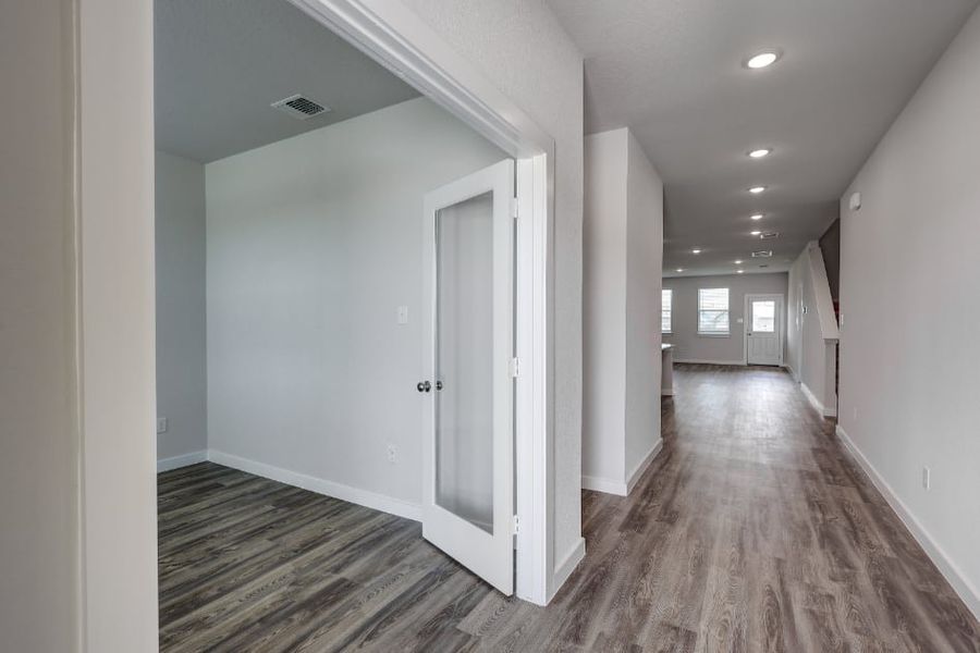 A hallway with white doors. A hallway with white doors.