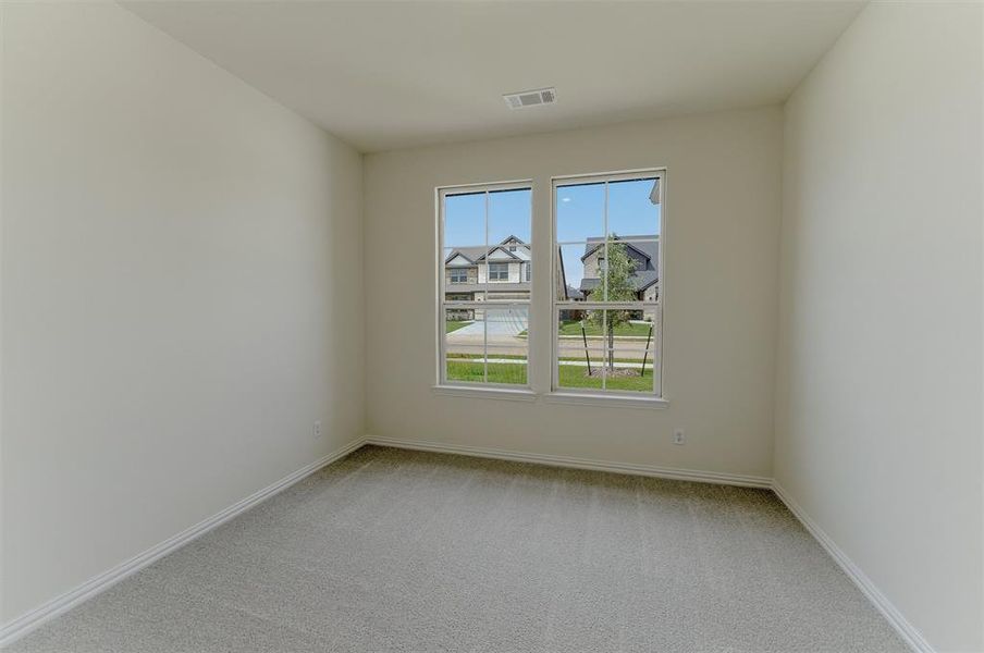 Room featuring light neutral wall paint, white baseboards, and gray carpet