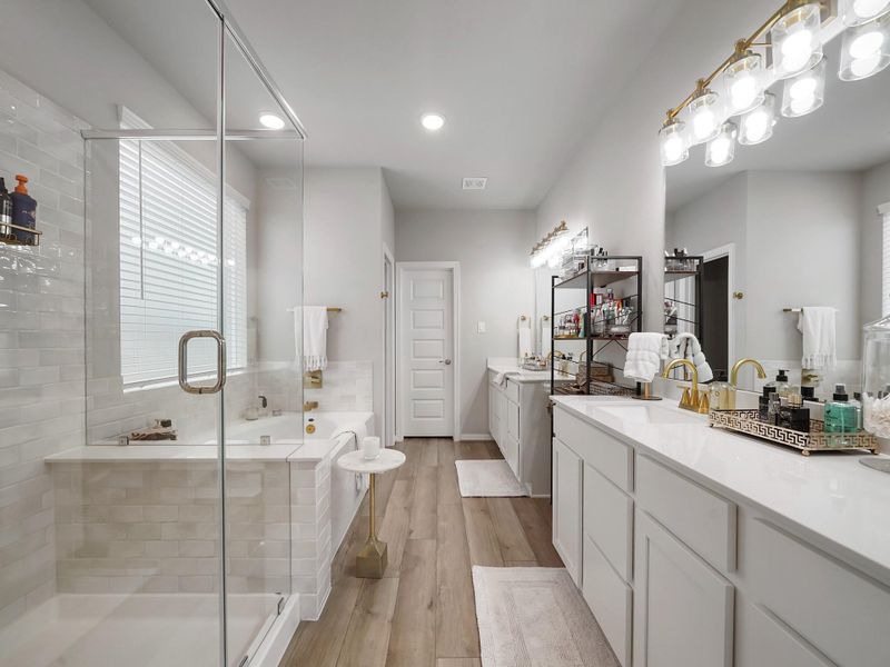 The ensuite bath offers a spa-like setting with a spacious layout designed for both comfort and convenience.