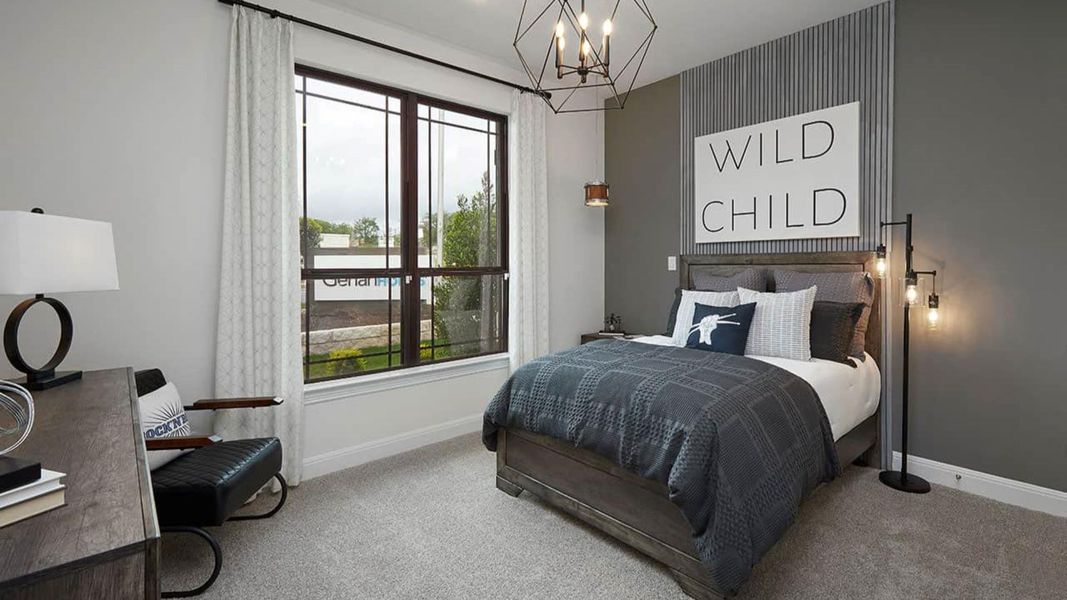 Carpeted bedroom featuring baseboards and a chandelier