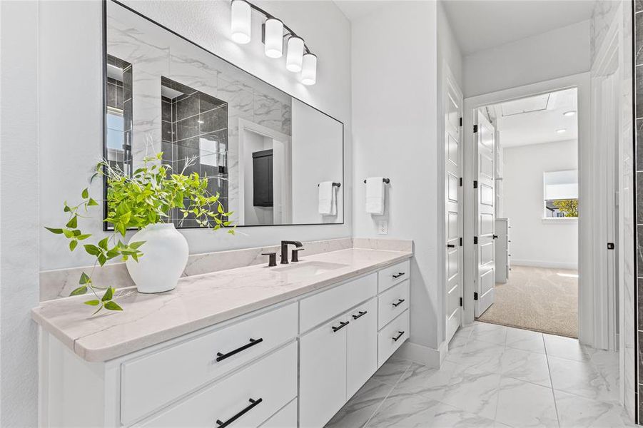 Full bathroom featuring light marble finish flooring and vanity