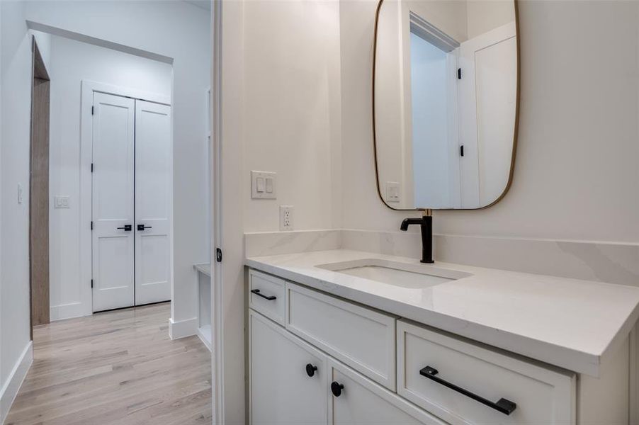 Bathroom featuring vanity and wood finished floors Bathroom featuring vanity and wood finished floors