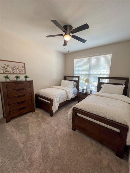 Bedroom with carpet floors and a ceiling fan