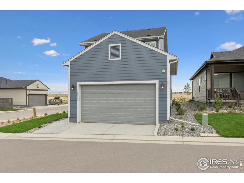 Front exterior of a new home in Kinston Cottage, Loveland, CO, highlighting curb appeal (Image 24).