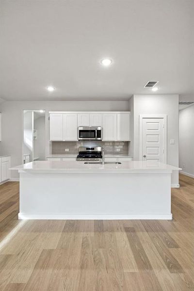 Kitchen in the Heisman home plan by Trophy Signature Homes – REPRESENTATIVE PHOTO