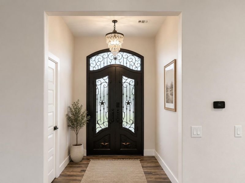 Ornate wrought iron entry doors welcome you into this inviting home.