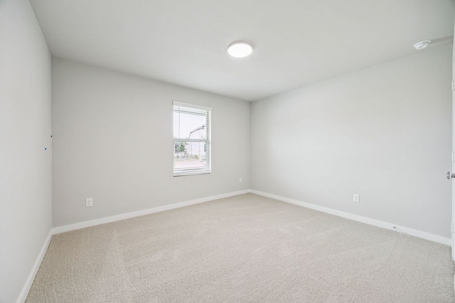 Bedroom in the Hayden home plan by Trophy Signature Homes – REPRESENTATIVE PHOTO