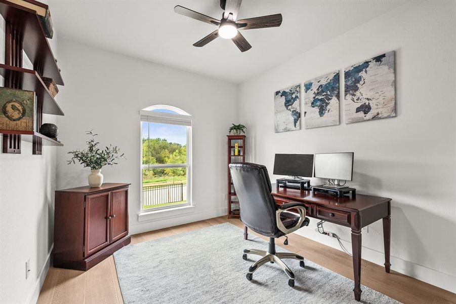 Office area featuring light wood-style floors and a ceiling fan Office area featuring light wood-style floors and a ceiling fan