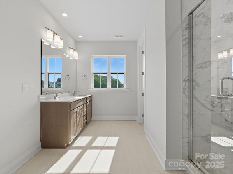 Primary En Suite Bath with Bright Window and Dual Vanity.