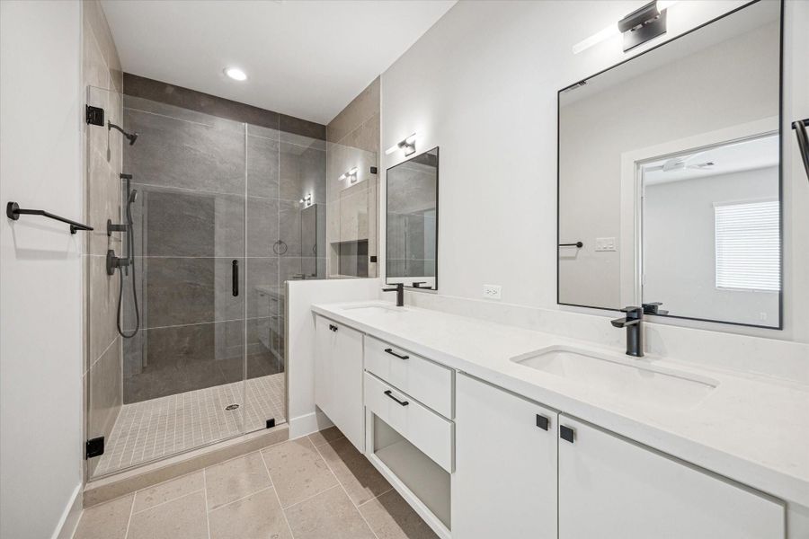 The primary bath offers quartz counters and an abundance of storage for keeping all your essentials organized.