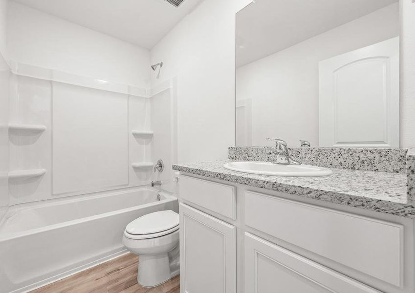 The guest bathroom with a large mirror and a shower/tub combination