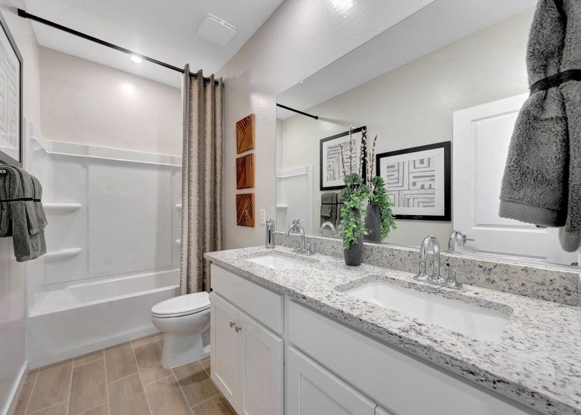 A bathroom with a tub sink and toilet.
