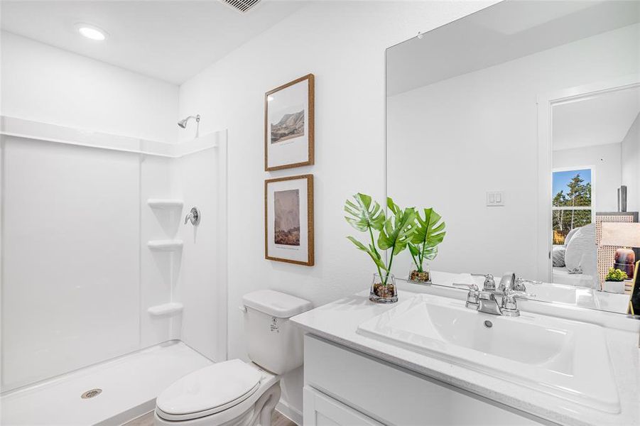 Bathroom with walk in shower, vanity, and toilet