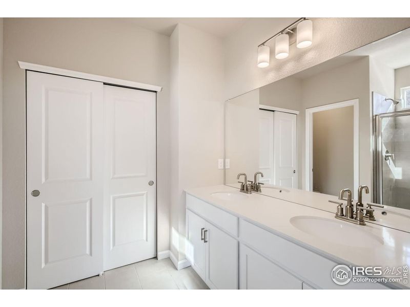 Primary bathroom *Photo not of actual home, but same floorplan and style*