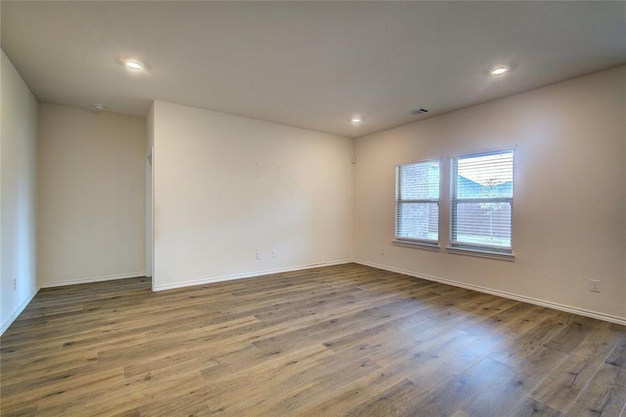 Empty room with wood finished floors and recessed lighting