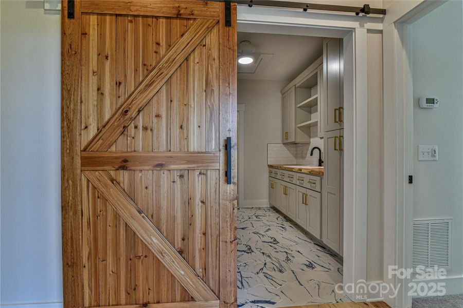 Barn door leading to the laundry room. Similar photo.