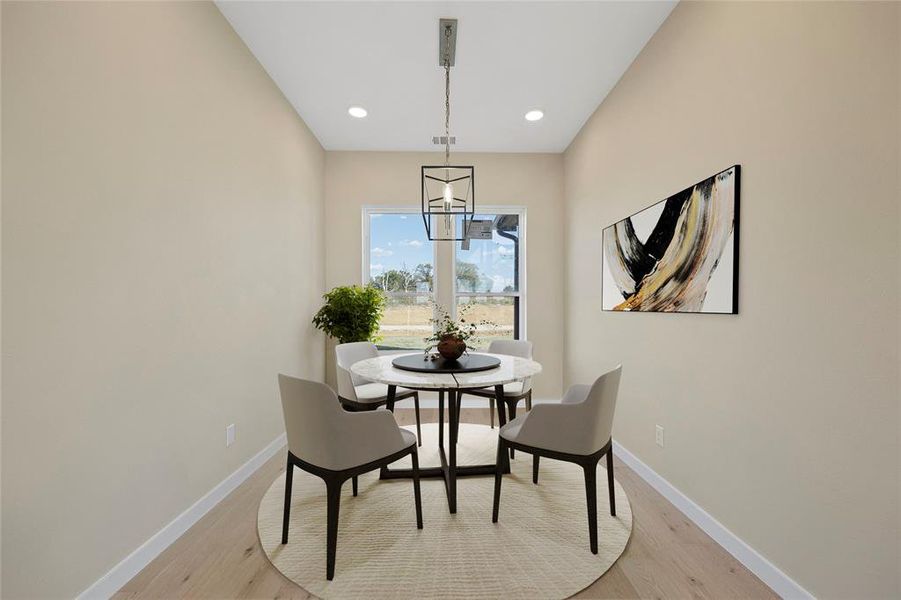 Dining area featuring light hardwood / wood-style flooring and an inviting chandelier