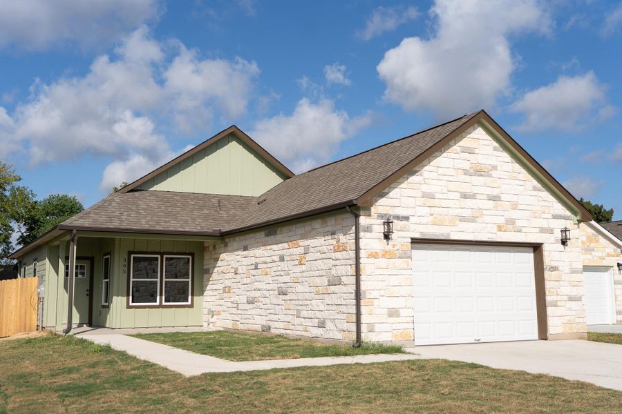 Front exterior of a new home in , Smithville, TX, highlighting curb appeal (Image 17).