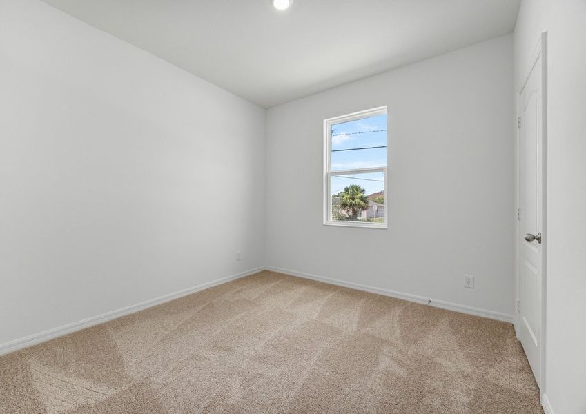 Secondary bedroom with carpet flooring
