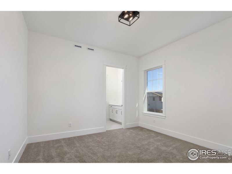 Secondary Bedroom on Main Floor with Ensuite Step In Shower for Ease Secondary Bedroom on Main Floor with Ensuite Step In Shower for Ease