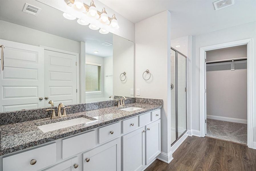 Primary Bathroom with Double Vanity Sinks and Separate Shower and Bathtub