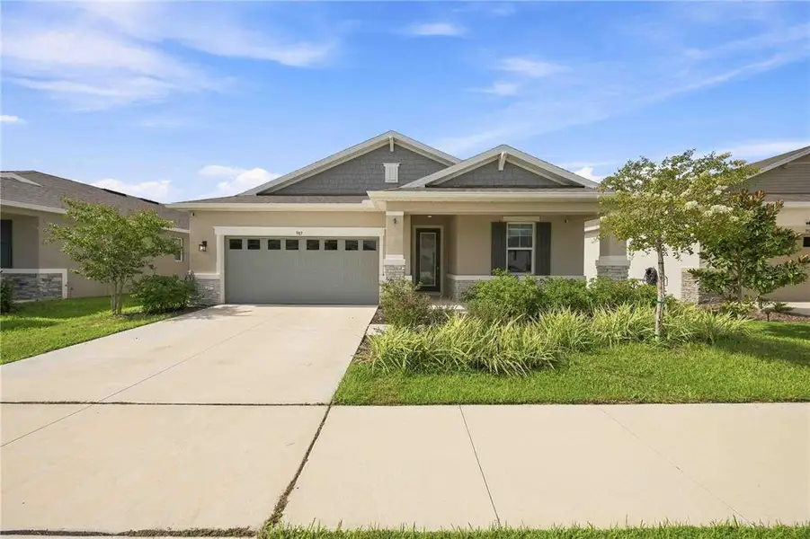Front exterior of a new home in Seasons at Eden Hills, Lake Alfred, FL, highlighting curb appeal (Image 21).