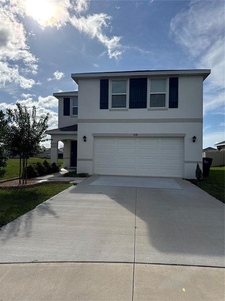 Front exterior of a new home in Evergreen, Bradenton, FL, highlighting curb appeal (Image 1). Front exterior of a new home in Evergreen, Bradenton, FL, highlighting curb appeal (Image 1).