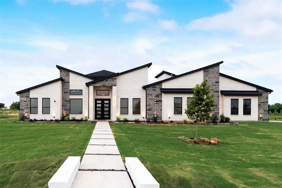 Contemporary home with stone siding, a front lawn, and french doors Contemporary home with stone siding, a front lawn, and french doors