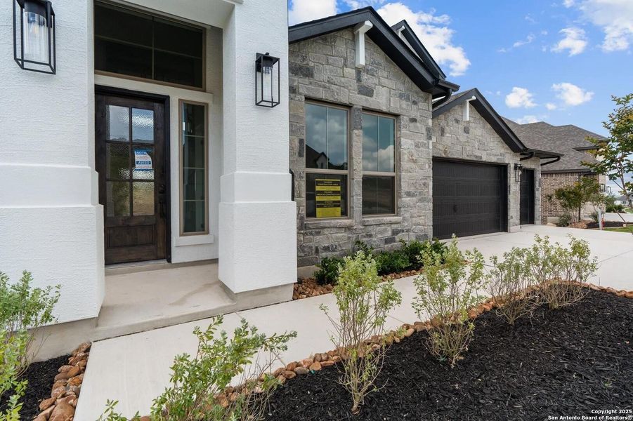 Front exterior of a new home in Esperanza - 70', Boerne, TX, highlighting curb appeal (Image 2).