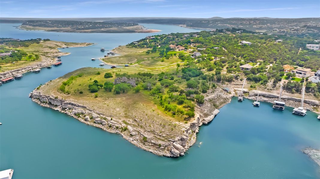 Photographed during historically low lake levels, this property still enjoys deep water on all sides—an uncommon and highly desirable feature for consistent boating and waterfront enjoyment.
