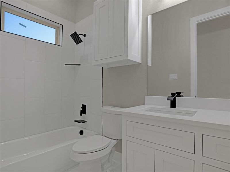 Full bathroom with toilet, vanity, and  shower combination