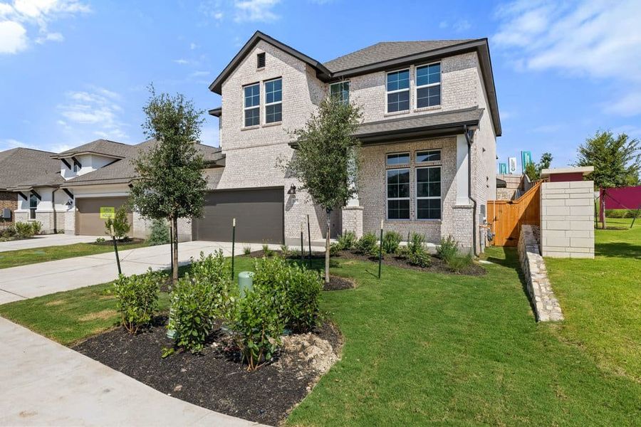 Front exterior of a new home in Lariat, Liberty Hill, TX, highlighting curb appeal (Image 22). Front exterior of a new home in Lariat, Liberty Hill, TX, highlighting curb appeal (Image 22).