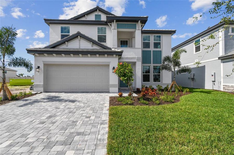 Front exterior of a new home in Hawkstone, Sarasota, FL, highlighting curb appeal (Image 23).