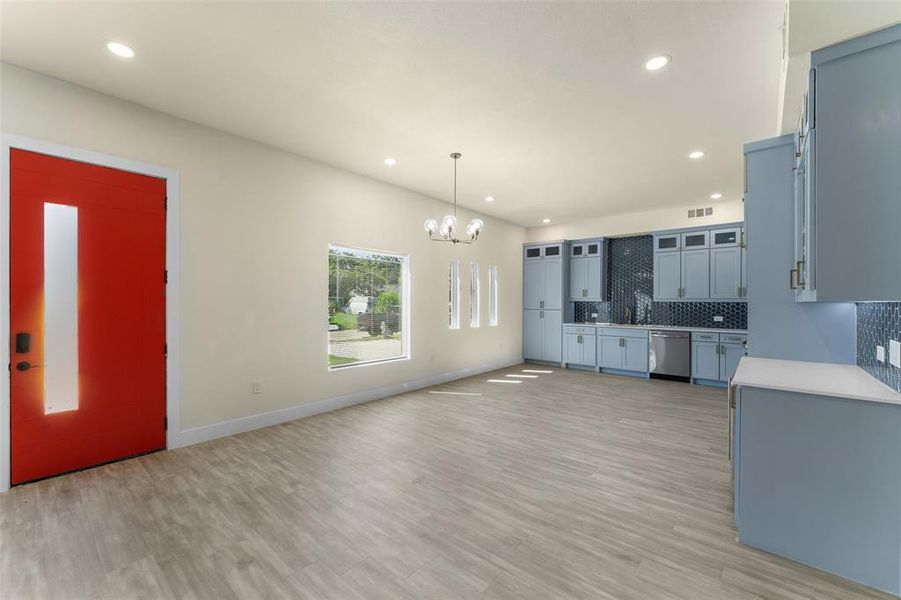 Unfurnished living room with a chandelier, recessed lighting, and light wood-style floors
