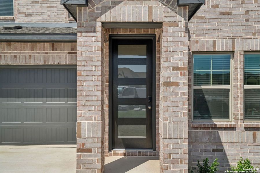 Front exterior of a new home in Arcadia Ridge - Premier Series, San Antonio, TX, highlighting curb appeal (Image 2). Front exterior of a new home in Arcadia Ridge - Premier Series, San Antonio, TX, highlighting curb appeal (Image 2).