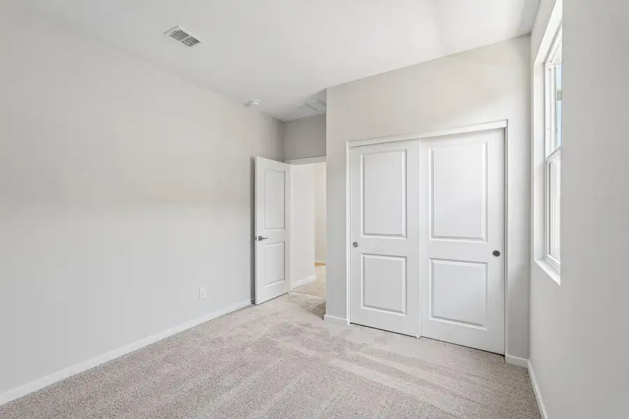 A hallway with white doors.