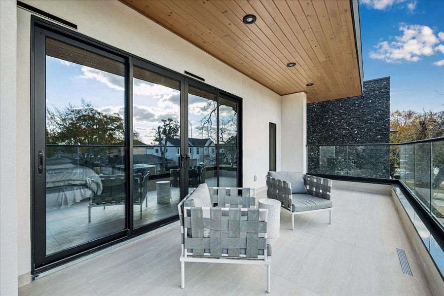 The private balcony awaits through sliding glass doors from the primary suite/